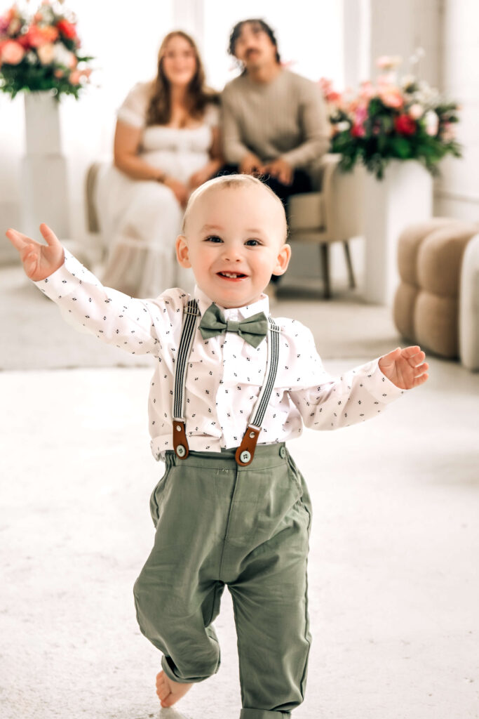 Lifestyle spring photoshoot with toddler wearing muted green and creamy white, matching the Sage Meadow color palette.