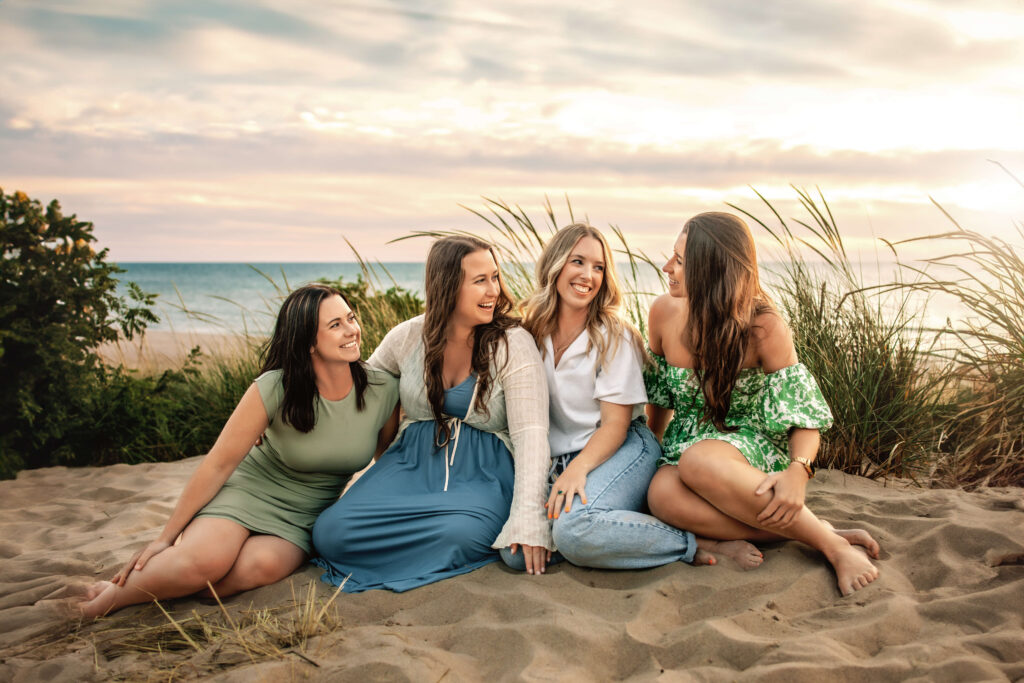 Four sisters laughing together in spring outfits inspired by the Willow Bloom palette, with soft green and neutral colors.